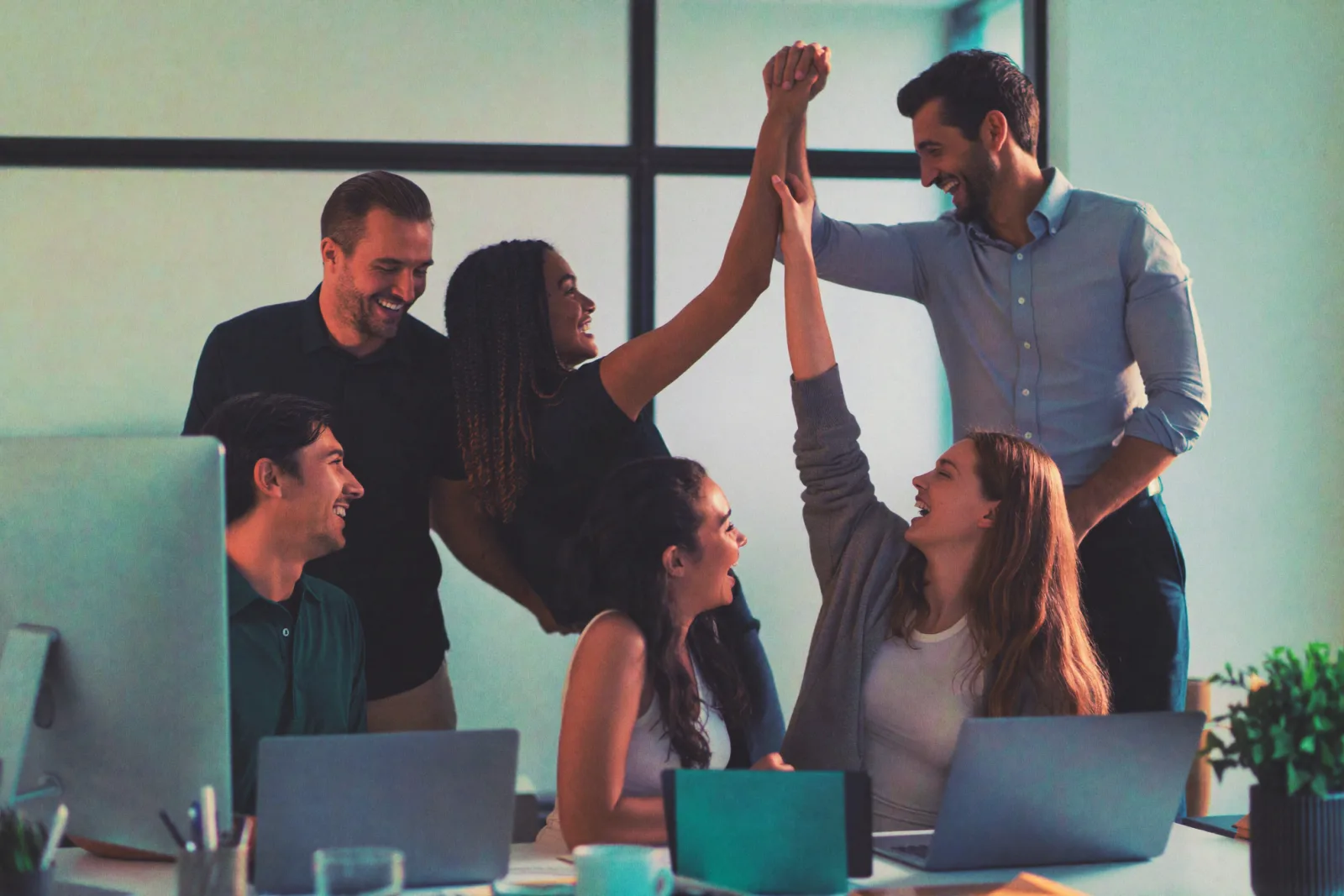 A customer team celebrating a win together